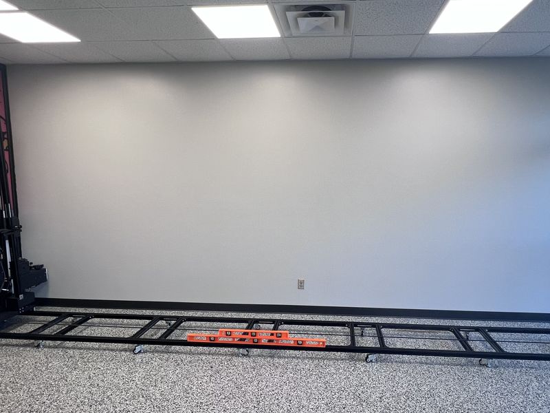Before: blank Wildcat Athletics wall with the WallPrint wall printer and its floor track set up