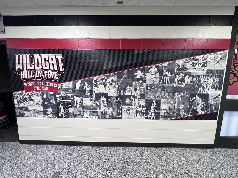 After: Wildcat Hall of Fame collage, Recognizing Greatness Since 1979, printed on the painted block wall